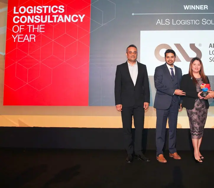 ALS team with the cube-shaped Logistics Consultancy of the Year trophy on stage at the Logistics Middle East Awards 2023